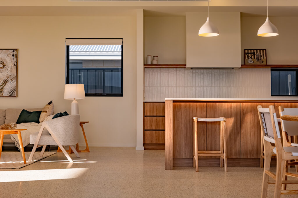 Open-plan kitchen and living area with a timber island bench
