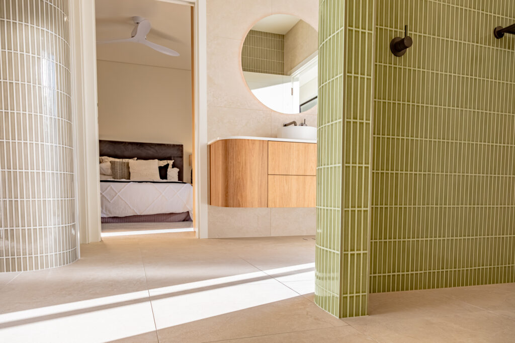 Main bedroom and ensuite with a curved green tiled wall
